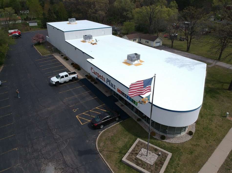 Fabric reinforced membrane after restoration by Roof Tech LLC showing complete transformation with durable coating system